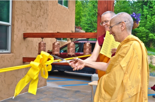 Abbess Ven. Thubten Chodron and Construction Manager Ven. Thubten Tarpa cut the ribbon together. Photos by: Sravasti Abbey. 