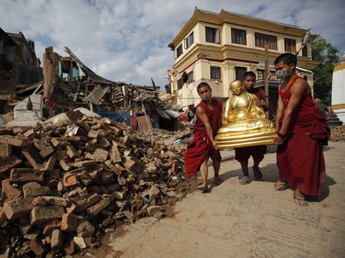 Buddhist monks recover a statue of a Buddhist deity from a monastery at Swayambhunath. Niranjan Shrestha/AP 