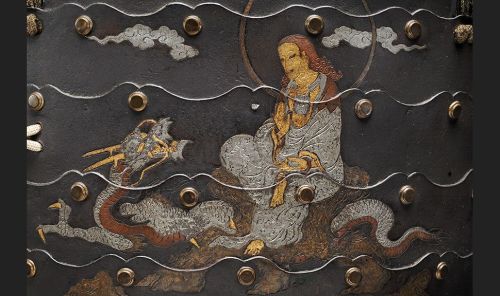Detail of Samurai armour Cuirass with the Bodhisattva Kannon sitting on the dragon (Ryūzū-Kannon) Japan. 16th century Metal, leather, textile Musée d’ethnographie de Genève Photo : J. Watts