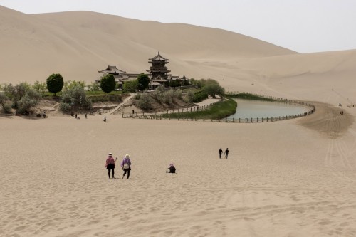 Tourists visit the Crescent Lake, one of Dunhuang’s major tourist sites along with the Mogao caves. (Gilles Sabrié/For The Washington Post)